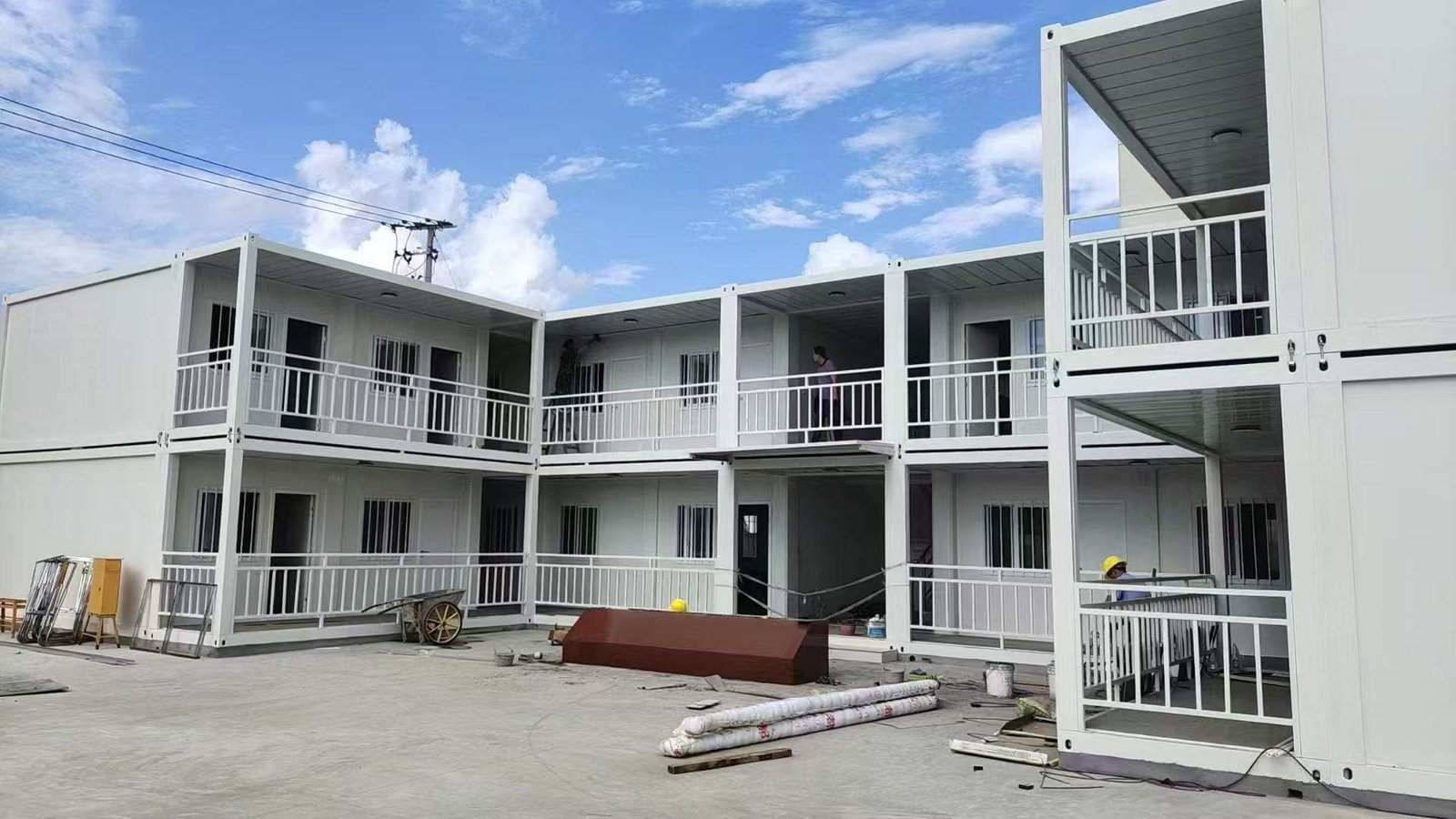 Two-storey container buildings arranged around a courtyard with covered walkways