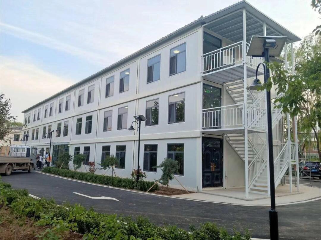Three-storey modular building with glazed entrance and external staircase